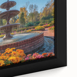 Close-up of a black framed canvas featuring a colorful, textured depiction of an architectural fountain.