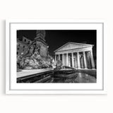 Abstract art print featuring geometric shapes in muted gray and blue tones, framed with a white mat.