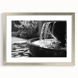 Textured abstract art print of architectural fountain design in muted gray, framed in silver, ideal for bedroom art.