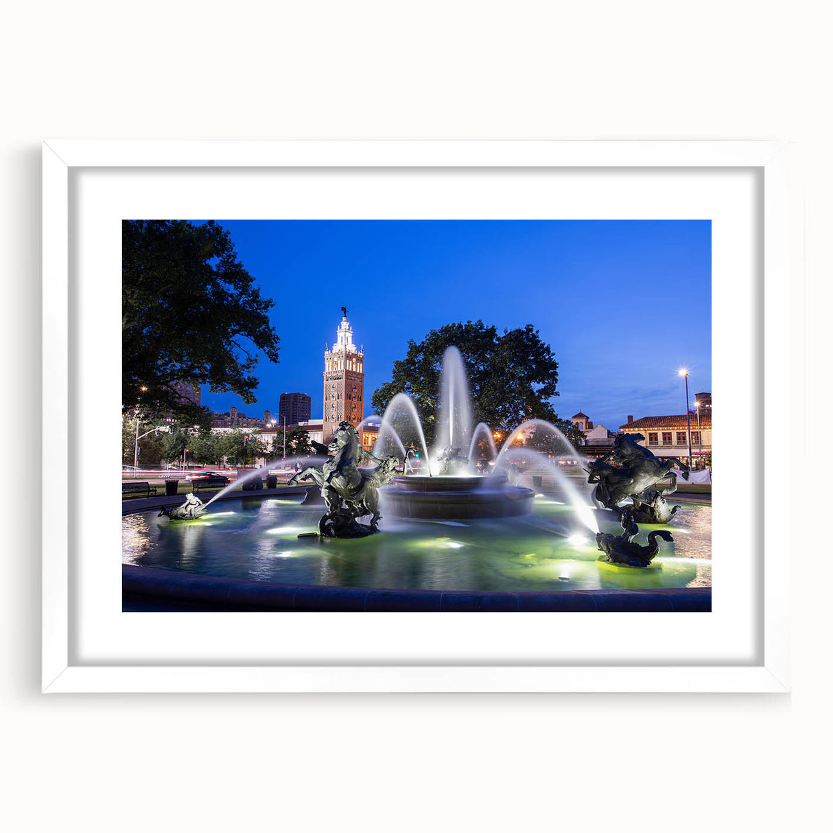 Abstract art print featuring a white fountain design on a black background, framed in white, ideal for dining room decor.