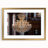 Textured abstract art print featuring irregular patterns in gold and black, framed with a golden mat.