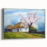 Framed canvas landscape art featuring a collection of vintage-style houses in muted black and colorful tones.