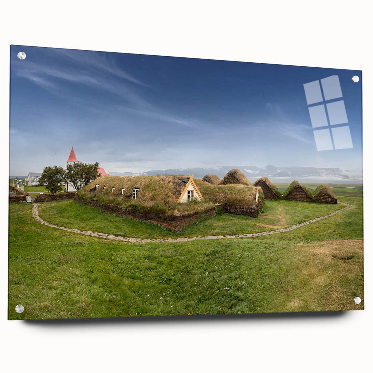 Large abstract wall art featuring a series of architectural house designs in muted earth tones on acrylic glass.