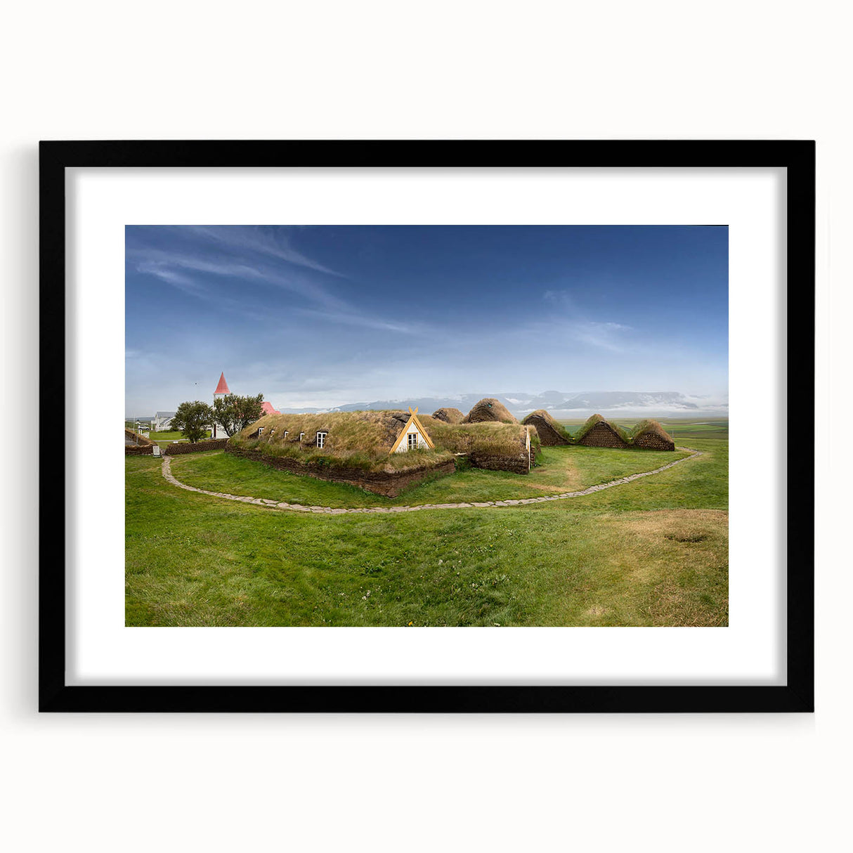 Extra large abstract art print featuring textured, colorful art of whimsical houses, framed in black.