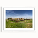 Abstract art prints featuring geometric house designs in muted beige and white tones, framed with a white mat.