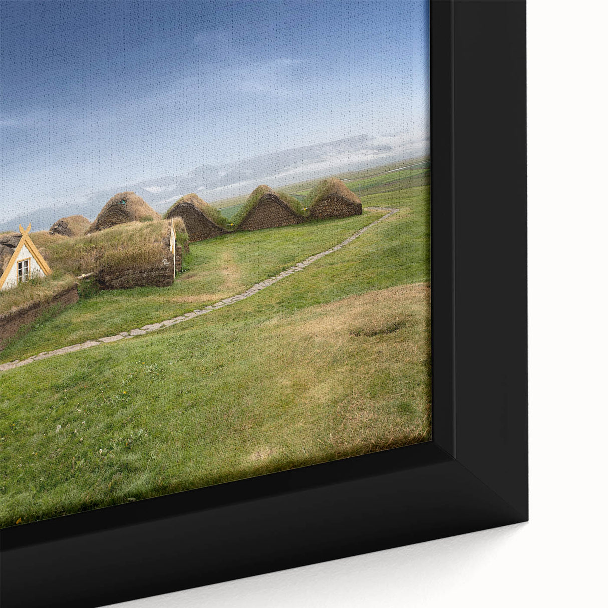 Black wall art featuring a close-up of colorful, textured houses on a framed canvas, suitable for a large living room.