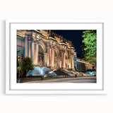 Abstract art print featuring geometric shapes in muted gray and blue tones on a white framed canvas.