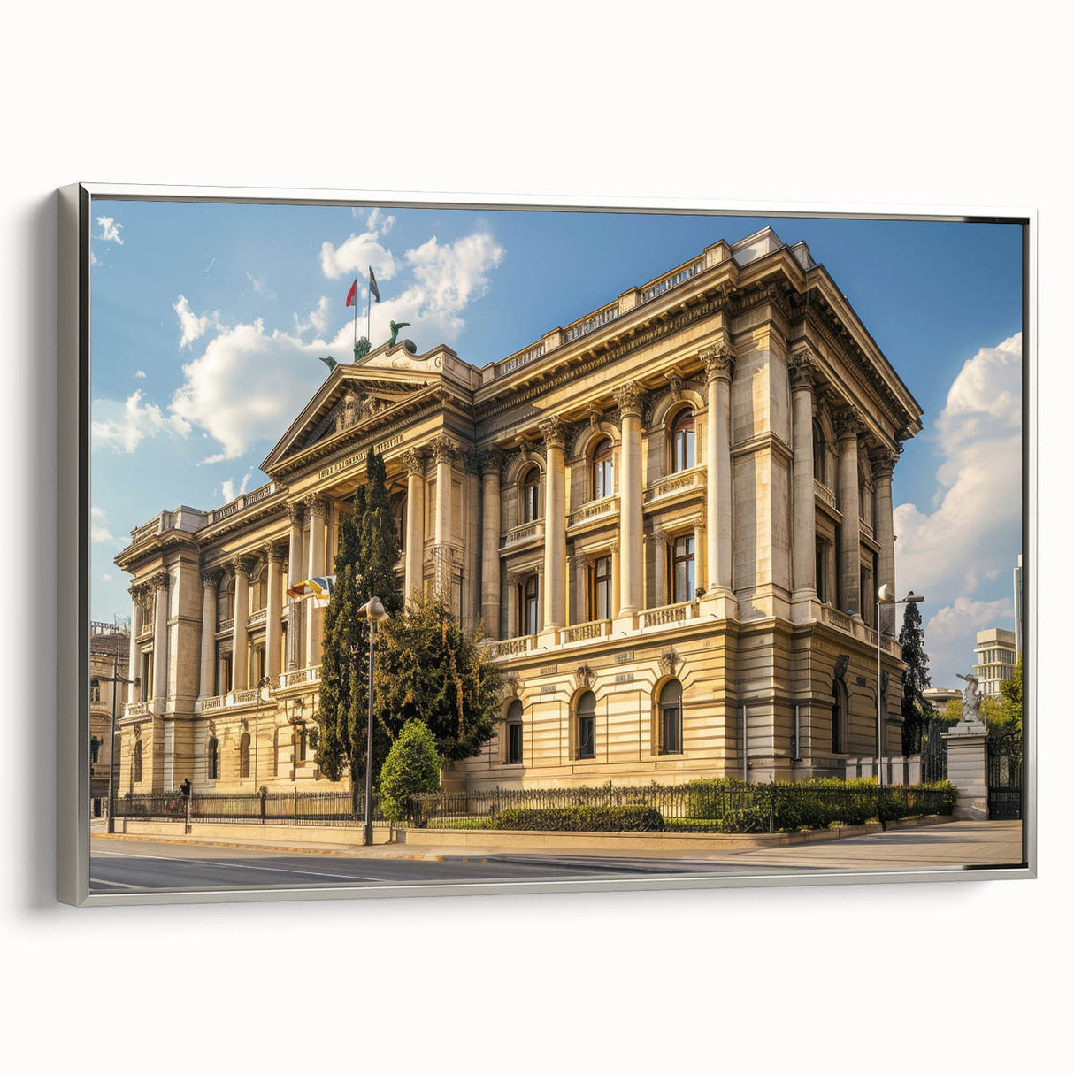 Landscape art painting of a city museum in colorful art style, displayed in a silver frame on a black wall.