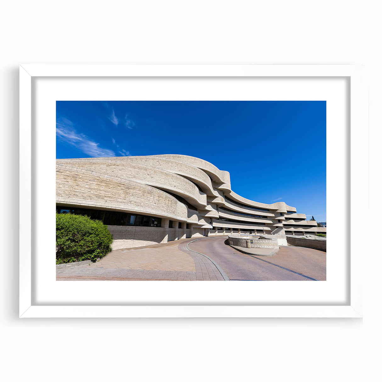 Abstract art print depicting geometric patterns in black and white, framed with a white mat.