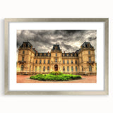 Abstract art print of a palace, using muted gold and white tones, framed in silver, ideal for dining room decor.