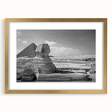 Textured abstract art print of pyramids in muted gold tones on a framed canvas, suitable for bedroom decor.