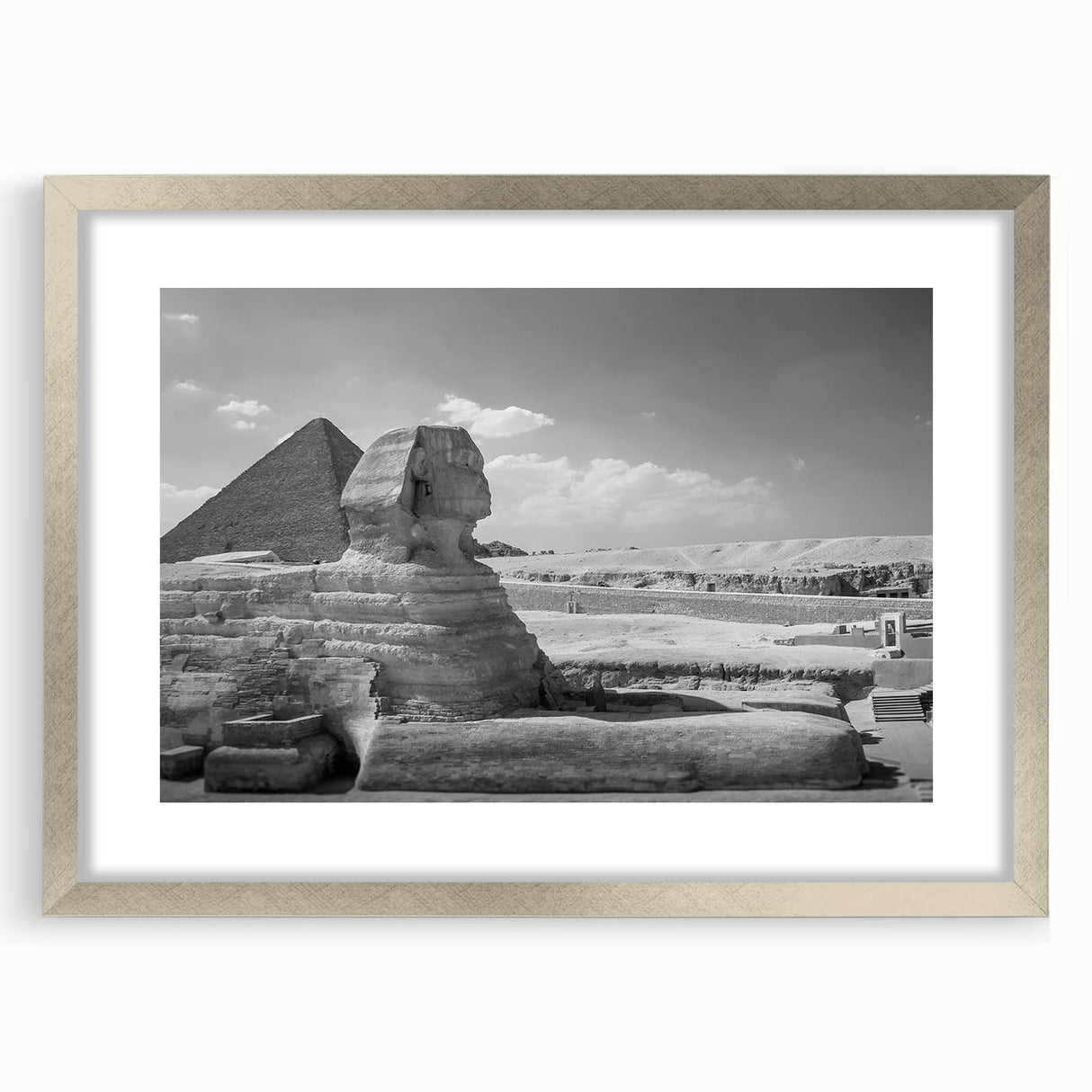 Abstract art print of geometric pyramids in muted gray, framed in silver, ideal for modern dining room decor.