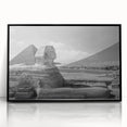 Large abstract wall art featuring geometric pyramids in muted gray, framed in black acrylic.