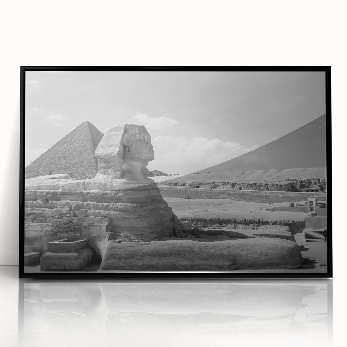 Large abstract wall art featuring geometric pyramids in muted gray, framed in black acrylic.