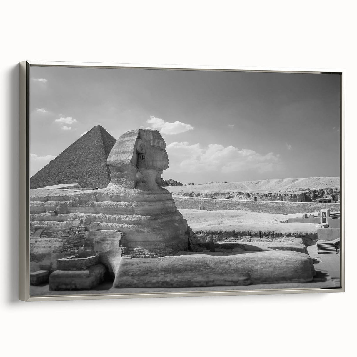 Vintage poster art of pyramids in muted black and silver tones on a framed canvas, ideal for living room decor.