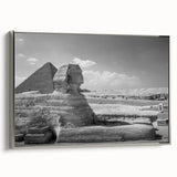 Vintage poster art of pyramids in muted black and silver tones on a framed canvas, ideal for living room decor.