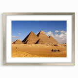 Abstract art print featuring geometric pyramids in muted earth tones, framed in silver, ideal for dining room decor.