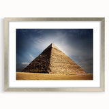 Abstract art print of geometric pyramids in muted gray, framed in silver, ideal for dining room decor.