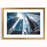 Textured abstract art print of skyscrapers in muted grays and golds, framed with a gold mat, suitable for bedroom decor.