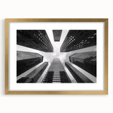 Textured abstract art print of skyscrapers in muted gold and gray tones on a framed canvas, suitable for bedroom decor.