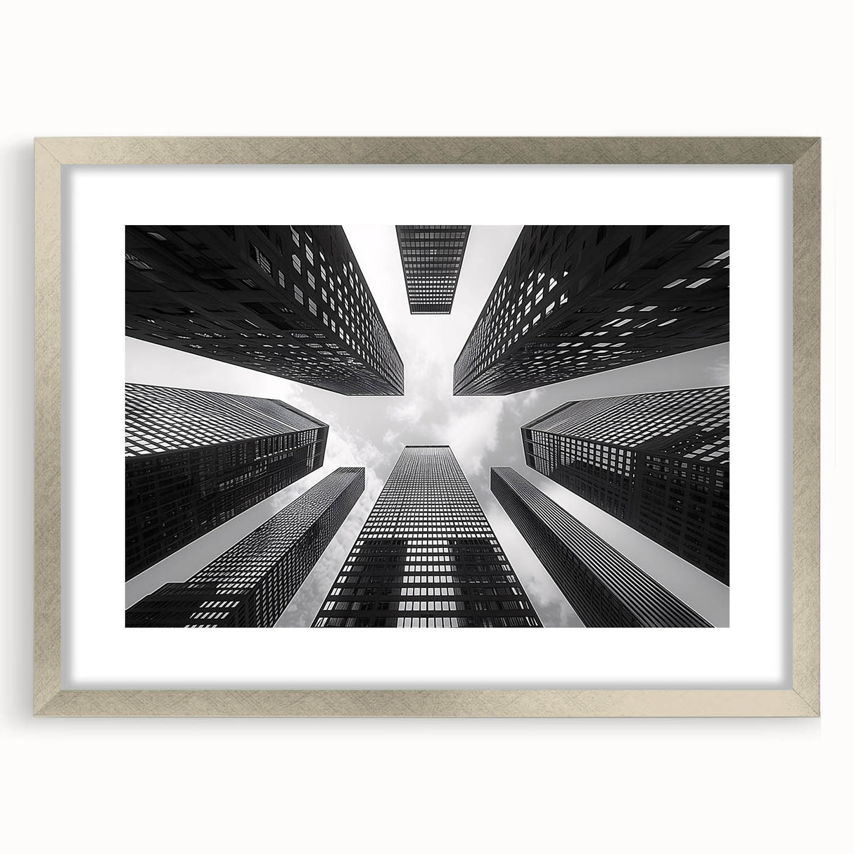 Abstract art print of a skyscraper design in silver frame with mat, in muted gray tones.