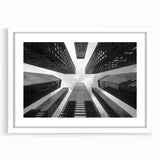 Extra large abstract art print of skyscrapers in muted gray tones on a white framed canvas, suitable for living room decor.