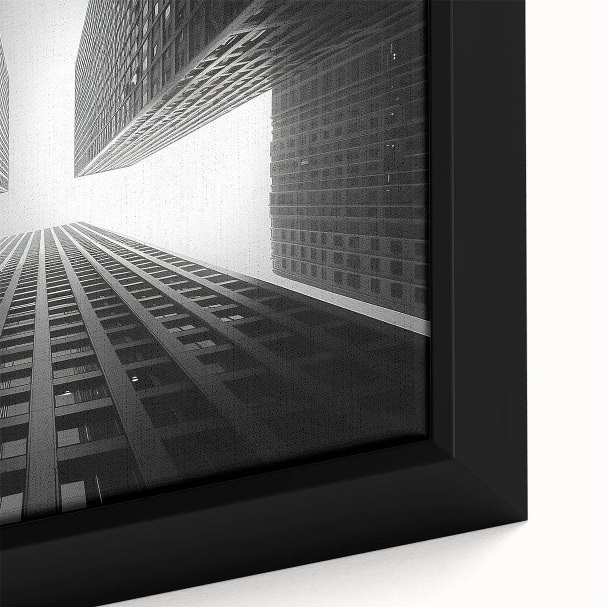 Close-up of a black wall art featuring a textured skyscraper design in vibrant colors on a framed canvas.
