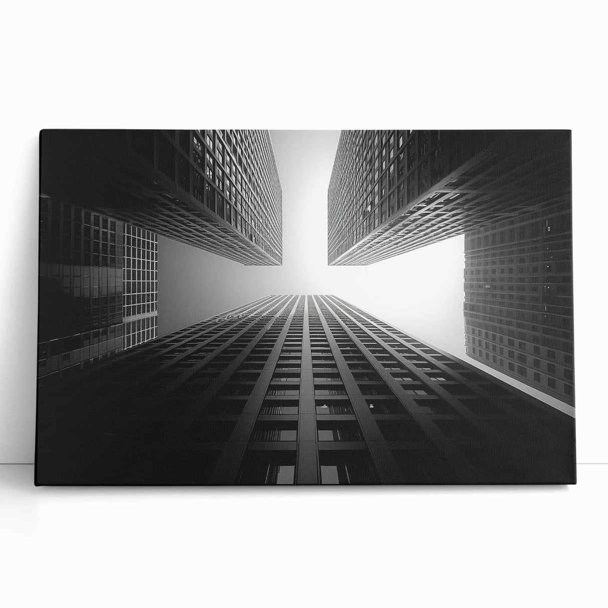 Black and white photo of a skyscraper on stretched canvas, ideal for kitchen wall art or bedroom ambiance.