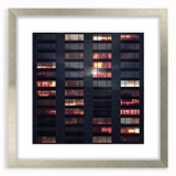 Abstract art print of skyscrapers in muted gray tones on a framed silver mat, suitable for bedroom or dining room decor.