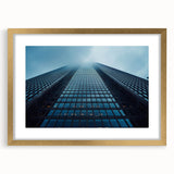 Textured art of abstract skyscraper design in muted gray, framed in gold, ideal for modern bedroom decor.
