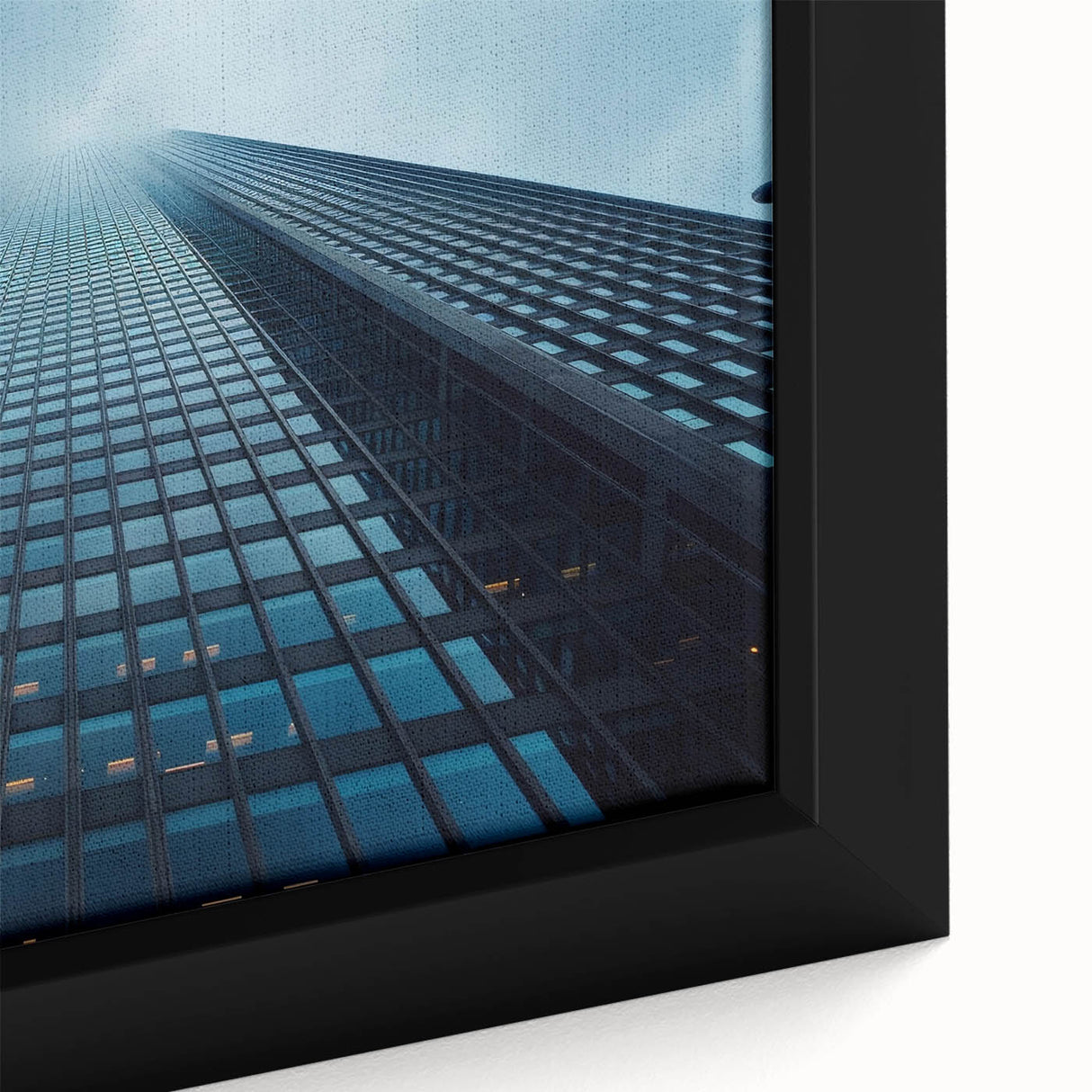 Close-up of a framed canvas featuring a black skyscraper design with colorful, textured elements.