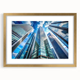 Textured art print of abstract skyscrapers in muted gray and gold tones, framed in gold, ideal for bedroom decor.
