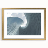 Textured art print of abstract skyscrapers in muted gray, framed in gold, ideal for modern bedroom decor.