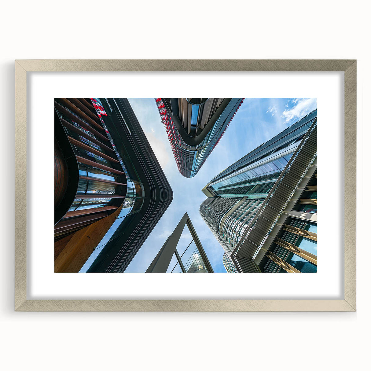 Abstract art print of skyscrapers in muted gray and silver tones, framed with a silver mat, ideal for dining room decor.