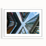 Extra large abstract art print of a textured skyscraper design in muted gray tones on a framed white mat.