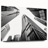 Large abstract wall art of skyscraper designs in gray and silver tones on acrylic glass.