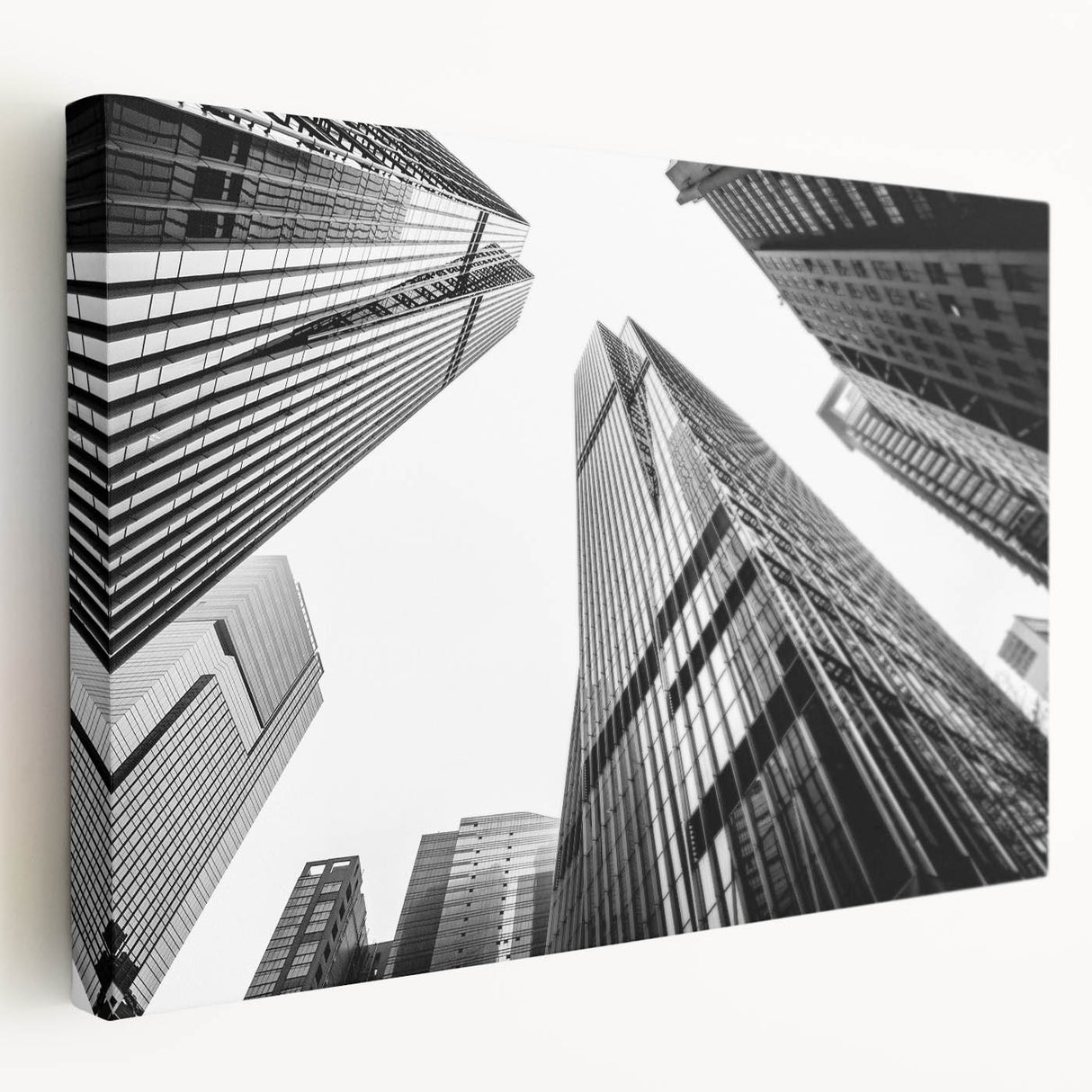 Large art print of modern skyscrapers on stretched canvas, showing detailed architectural designs in monochrome.