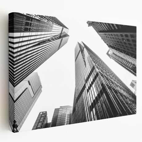 Large art print of modern skyscrapers on stretched canvas, showing detailed architectural designs in monochrome.