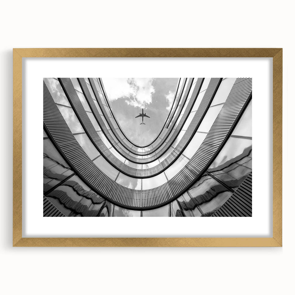 Textured abstract art print of skyscrapers in gold frame with mat, in muted gray tones, suitable for bedroom art.