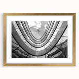 Textured abstract art print of skyscrapers in gold frame with mat, in muted gray tones, suitable for bedroom art.