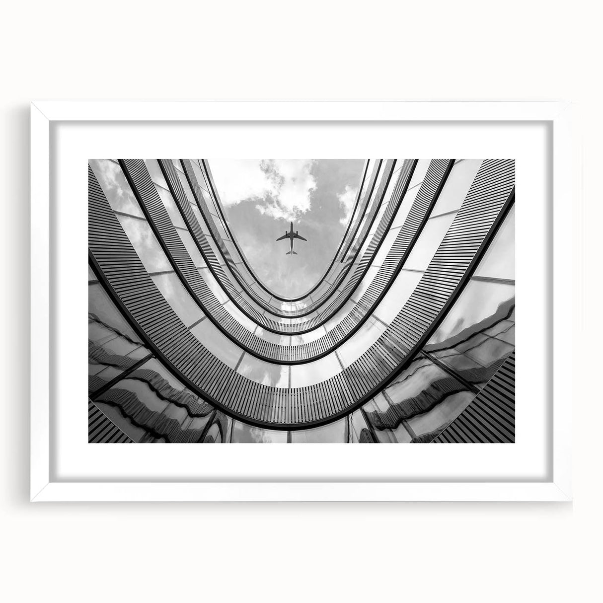 Extra large abstract art print of a skyscraper, in textured gray tones, framed with a white mat.