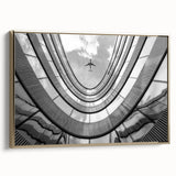 Framed canvas featuring a vintage poster-style landscape of skyscrapers in gold, black, and colorful accents.