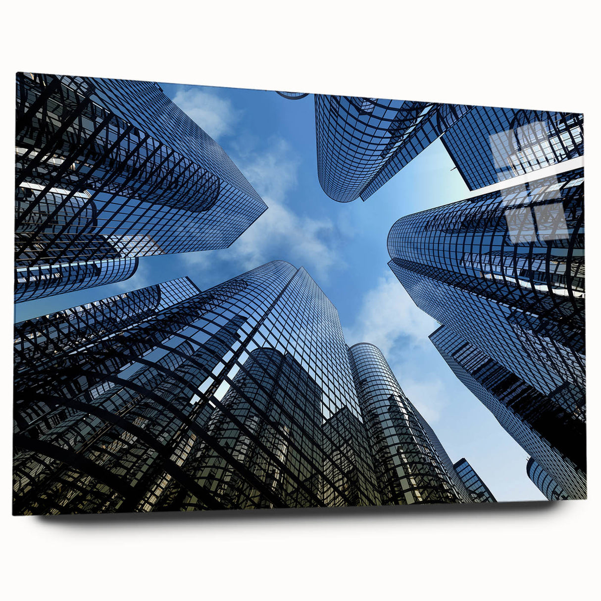 Large abstract wall art on acrylic glass depicting modern skyscrapers in gray and blue tones.