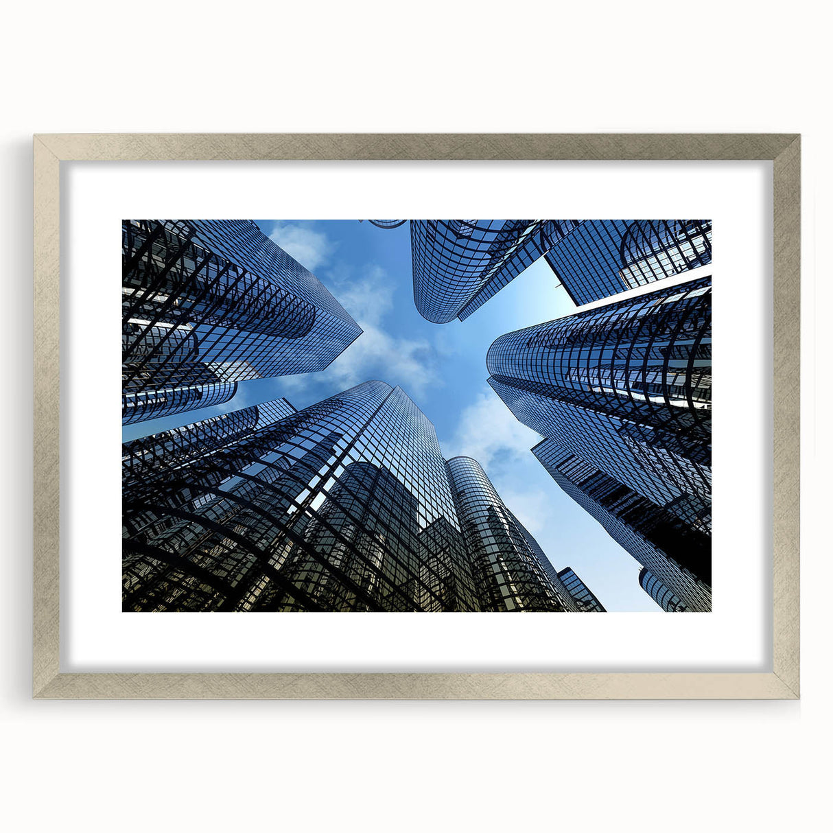 Abstract art print of a skyscraper in muted gray tones, framed in silver, suitable for dining room or bedroom decor.