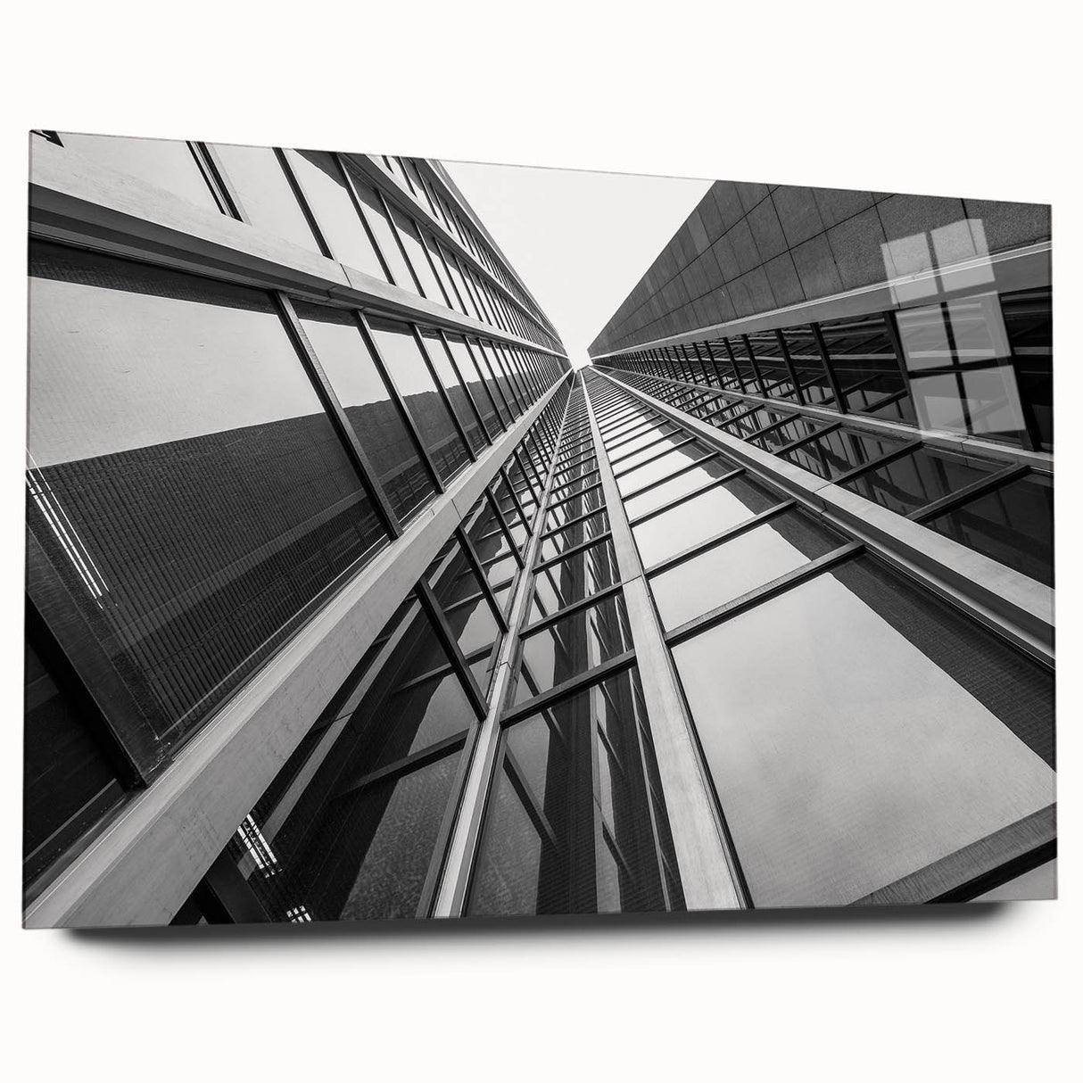 Large abstract wall art of a skyscraper design in muted gray and blue tones on acrylic glass.