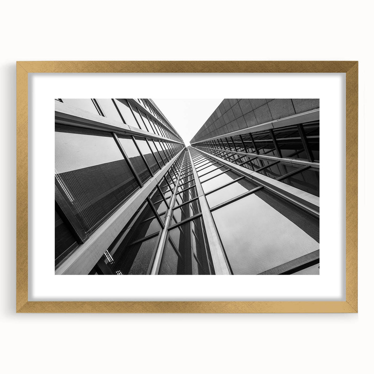 Textured abstract art print of skyscrapers in gold frame, ideal for modern bedroom ambiance.