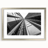 Abstract art print of a skyscraper design in silver frame with mat, ideal for modern dining room decor.