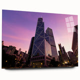 Large abstract wall art on acrylic glass showing a blurred skyscraper, in cool blue and gray tones.