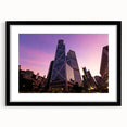 Extra large abstract art print of colorful, textured skyscrapers on a framed black mat, ideal for living room decor.