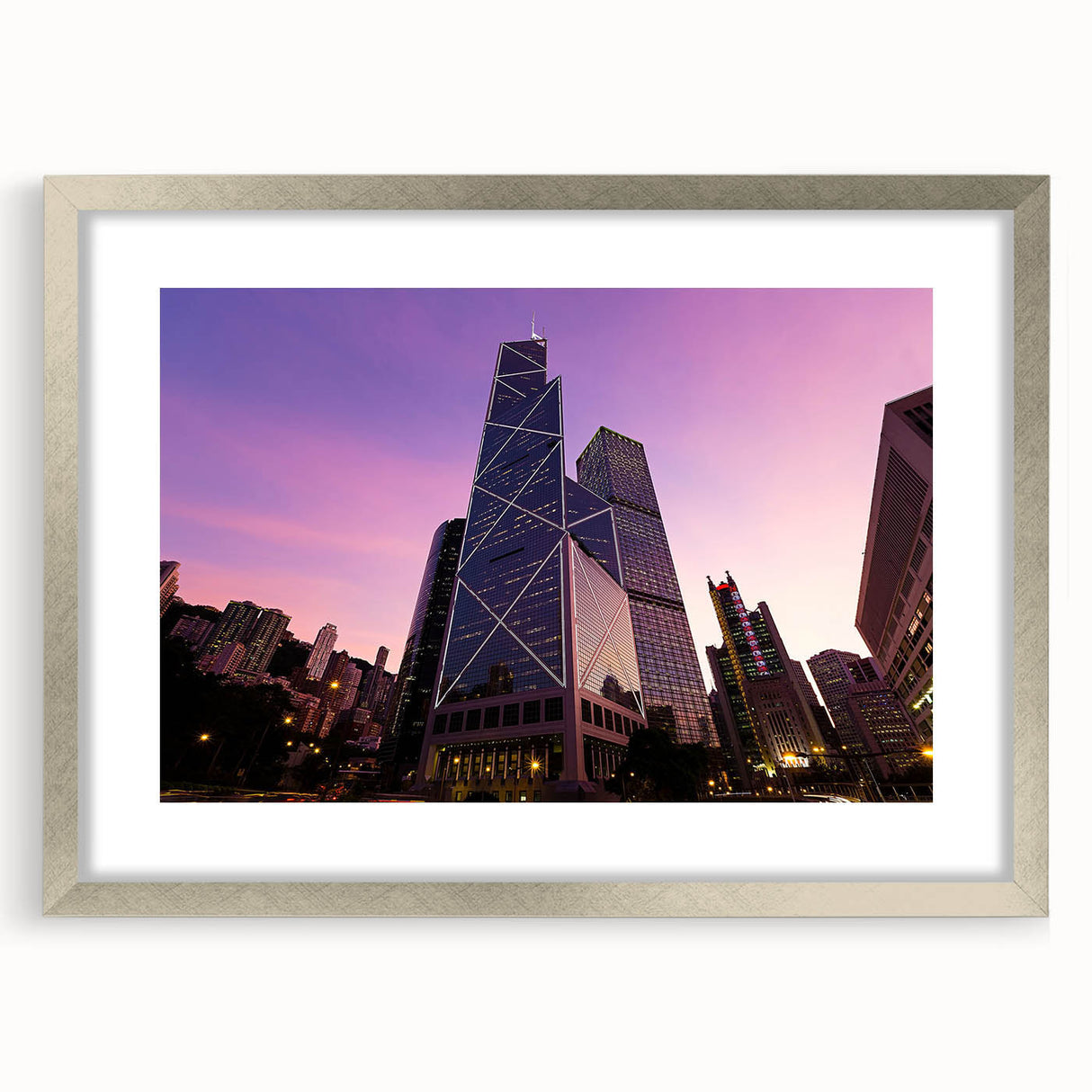 Abstract art print of a skyscraper in muted gray tones on a framed silver mat, suitable for dining room decor.